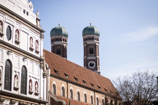 The two newly renovated towers of the Frauenkirche with blue sky and houses in the foregrou