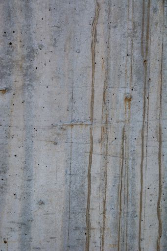 A closeup shot of naturally weathered grungy wall with oil paint leftovers on marble
