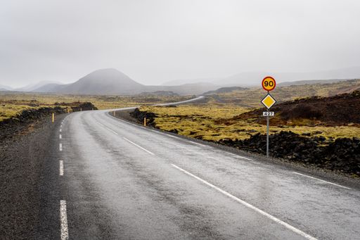A deserted road with mountains hidden in the mist. Iceland