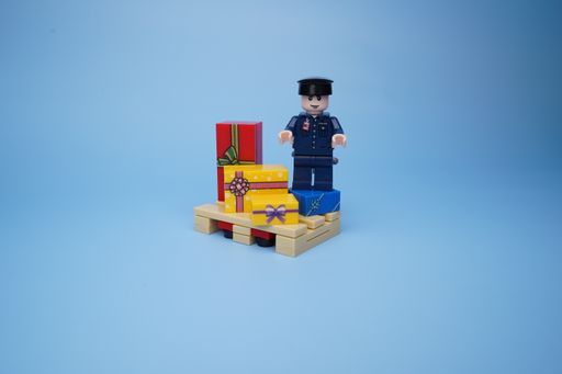 A Lego policeman isolated against an empty blue background