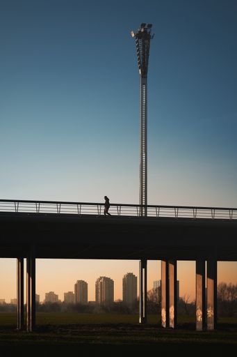 A person walks on a bridge at sunset, Zagreb, Croatia.