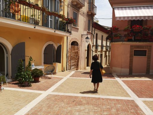 A female walking along the Piazza D'albenzio in province of Pescara, Abruzzo, Italy