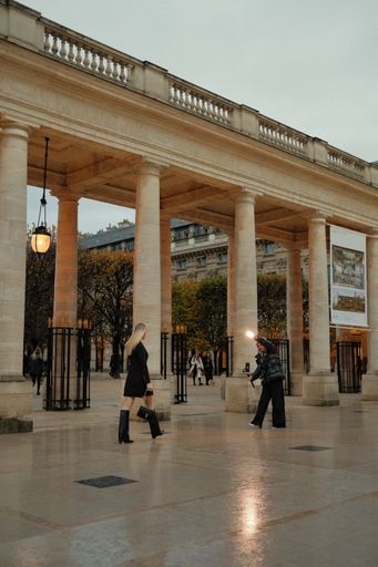 A photographer taking photos of a model in a street setting. Paris, France