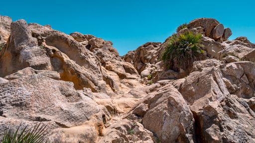 A low angle shot of a rocky mountain on a sunny day