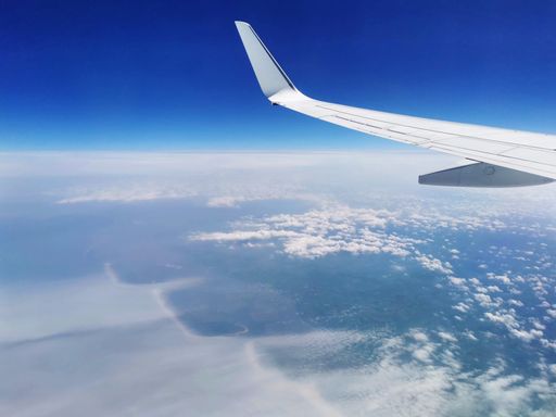 An atmospheric shot of fluffy clouds in the blue sky seen from an airplane - perfect for wallpapers