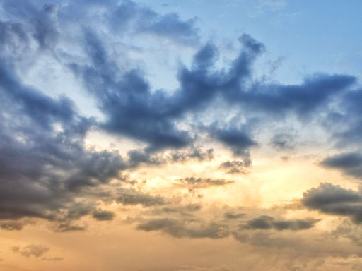 A beautiful view of dense fluffy clouds in the blue and yellow toned sky - perfect for wallpapers