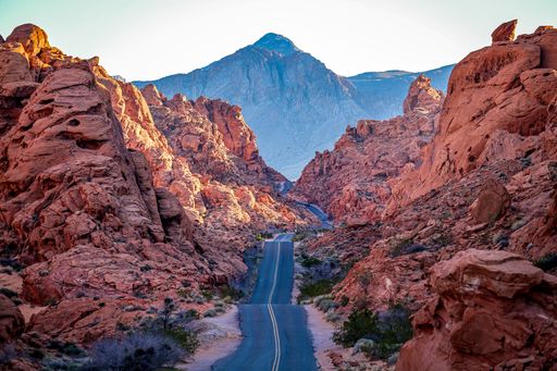 A scenic road meandering through the majesty of the orange landscape of Valley of Fire Nevada