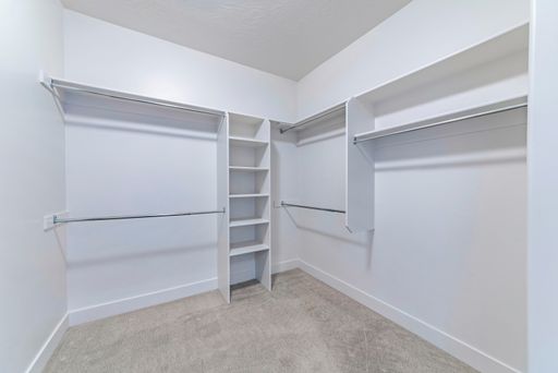 The white wooden shelves and racks in the pantry or wardrobe room