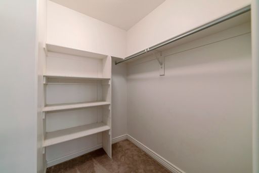 an empty white room with an empty wardrobe