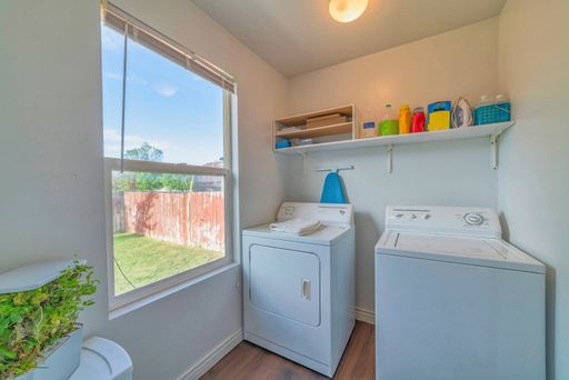 A laundry room with a washing machine and a dryer