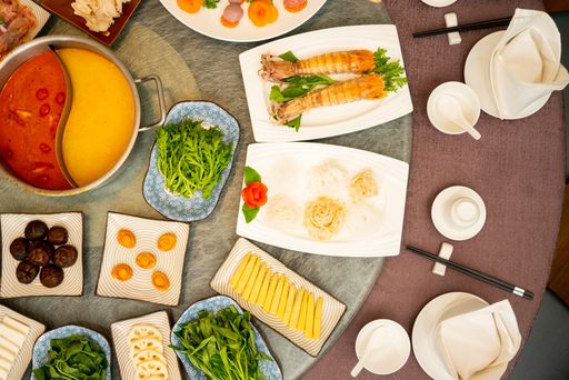 A high angle shot of a side dishes around a soup on an oriental table