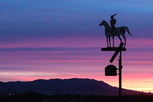 Robson's Arizona Mining World features an aged vintage sign with using Native American imagery on horseback to advertise their ghost town experience.