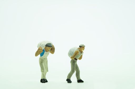 A closeup shot of small figure toys of workers on an isolated background