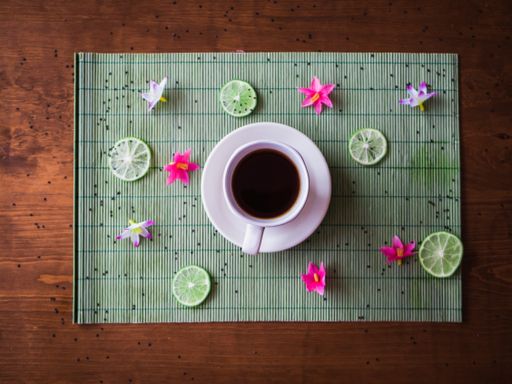 A high angle shot of a hot tea in a white cup placed on the table