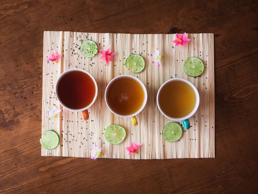 A high angle shot of three different shades of hot tea in the cup