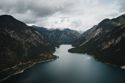 A scenic view of the Plansee and peaceful mountains in Tyrol, Austria