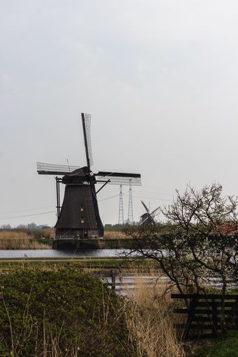 A vertical shot of windmills in Kinderdijk, the Netherlands