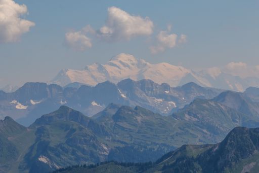Majestic mountain flanked by peaks under clear blue sky