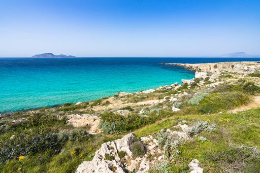 An aerial shot of Favignana coastline at Cala Rossa bay in the Aegadian Islands, Sicily