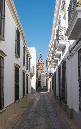 Old buildings and doors line a narrow street