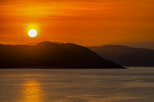 A beautiful shot of mountains with the sun in the background in northern Western Australia