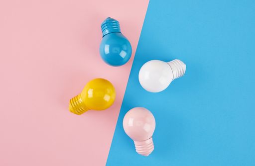A top view of light bulbs on a pink and blue background
