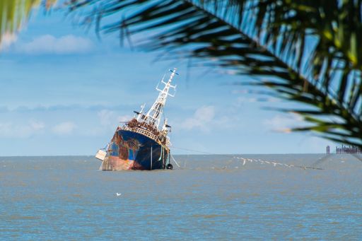 An old rusty abandoned ship on the sea