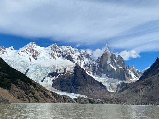 The snow and ice cover the Cerro Torre mountains reflecting on a lake