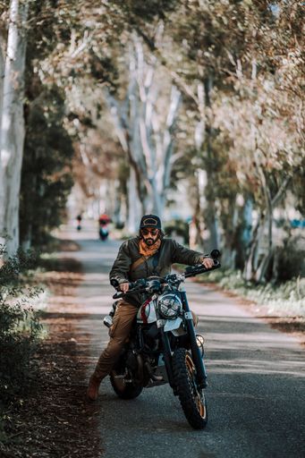 A man seated on a motorcycle on the street