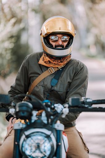 Man in helmet rides motorcycle on street