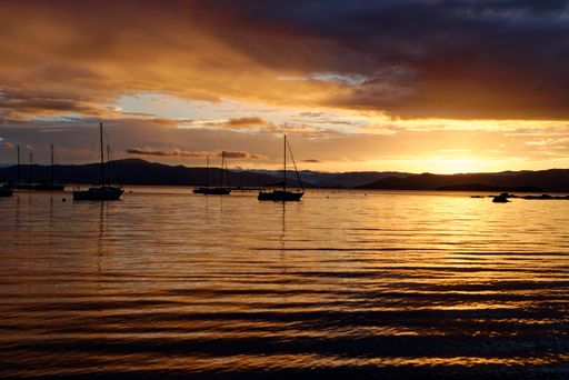 A beautiful orange toned sunset with boat silhouettes in Santo Antonio de Lisboa,Florianopolis,Brazil