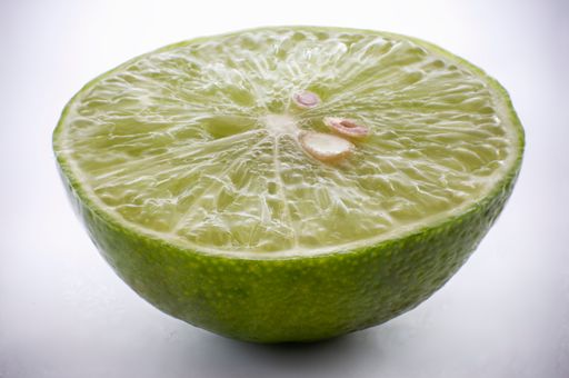 A closeup shot of sliced lime isolated on white background