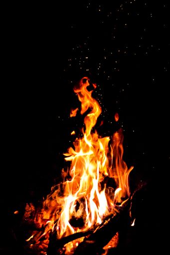 A vertical shot of a large burning bonfire