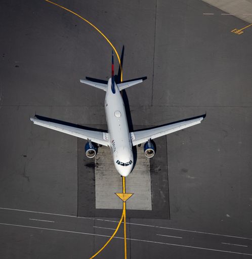 An aerial view of an aircraft parked at an airport