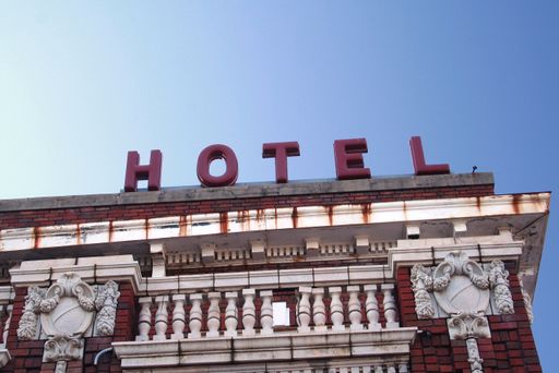 A closeup shot of a hotel sign on the rooftop of a building