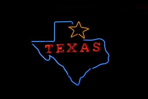 A glowing blue outline of the map of Texas with a golden star and a red text saying Texas inside it