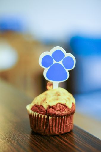 A closeup shot of a homemade chocolate muffin with a palm sticker on top