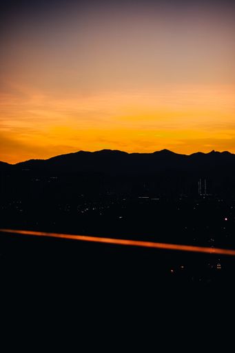 A silhouette of vast mountain landscape during a beautiful sunset sky