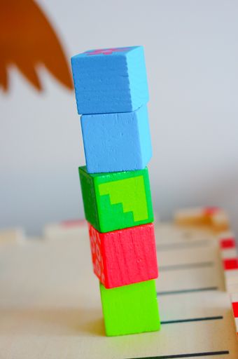 A stack of colorful toy cubes on a blurred background