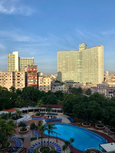 A view of a pool and buildings from a room in havana