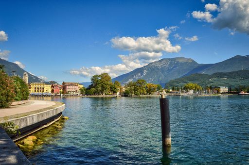 landscape with view to Riva del Garda, mountains, Monte Brione, lake, water, pier, promenade, waterfront, pale, blue sky