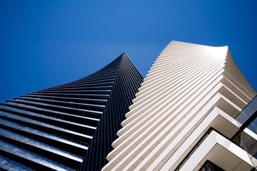 A low angle shot of Axis Towers in Tbilisi, Georgia under a blue sky