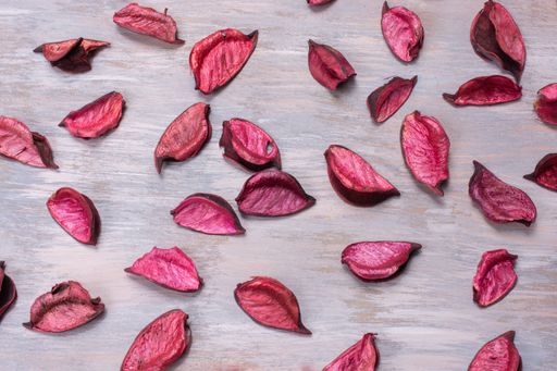 A closeup shot of red rose petals on a wooden surface