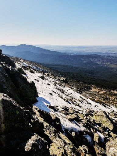 The mesmerizing view of the Penalara mountain in Spain covered in snow on a sunny day
