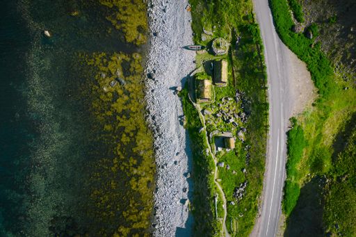 An aerial view of road, water, and land