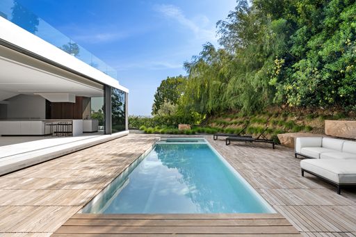 Contemporary outdoor space with wooden floor and white sofa