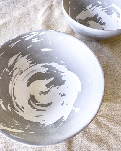 Bone dry clay bowls with a hakeme glaze brushing technique in white underglaze