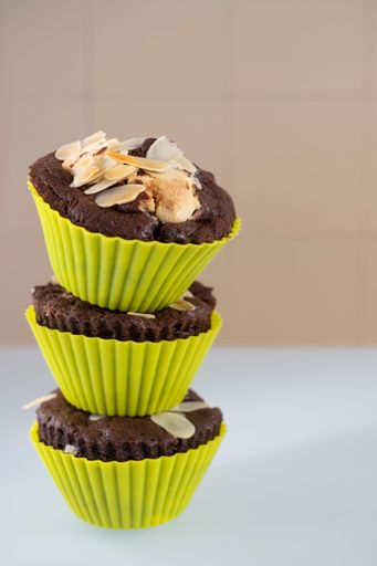 A closeup shot of homemade chocolate muffins stacked on top of each other