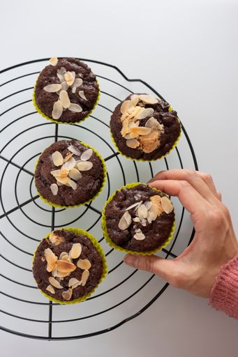 A closeup shot of homemade chocolate muffins on a cooking rack