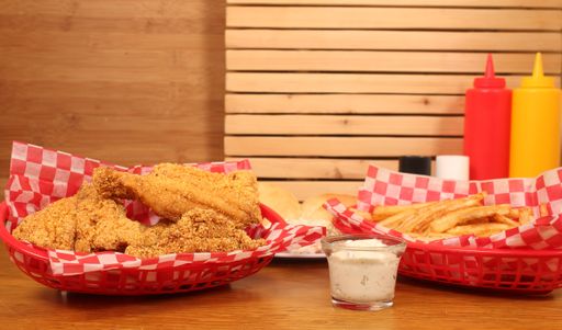 A fast-food diner with baskets of french fries and fried catfish